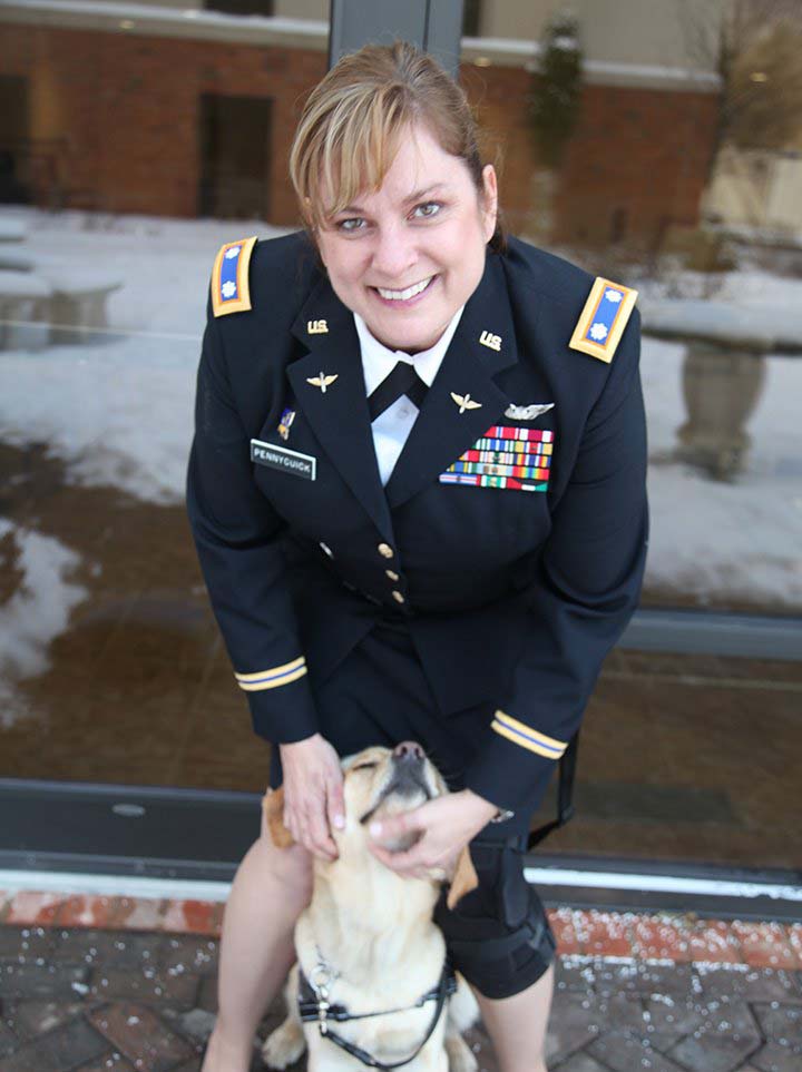 Combat Veteran, Tracy Pennycuick, in uniform with dog. Appearance in military uniform does not imply or constitute endorsement by the US Department of Defense or any of its particular military departments
